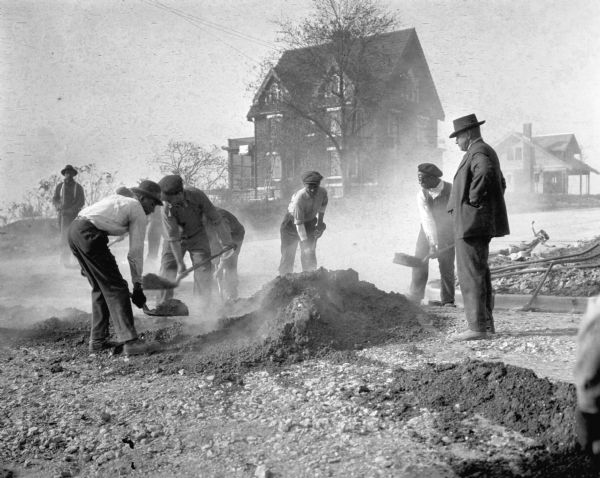 Street construction at the corner of Regent and Roby Road in Madison. The home of the photographer, W.H. Dudley, is in the background