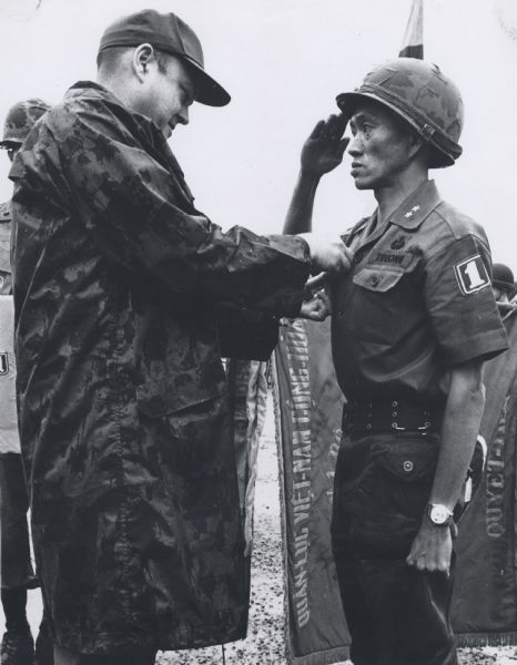 The Secretary of Defense presentoing a medal to a South Vietnamese soldier during a South Asian tour.