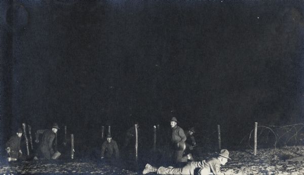 Barbed wire training under Lt. Johnson. An unusual nighttime photograph from the Victor Morris album, at Camp Custer.