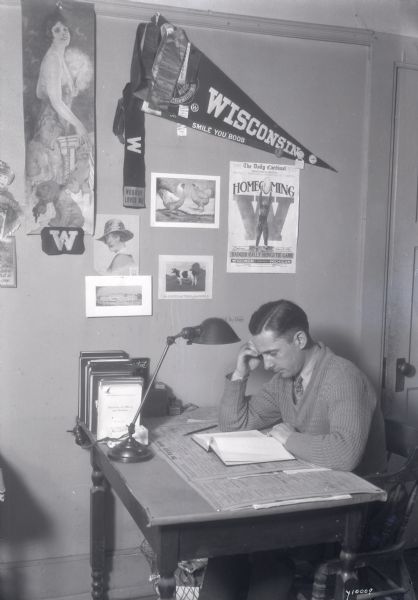 Posed photograph of a University of Wisconsin student studying in his room.