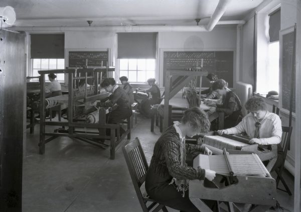 Girls' weaving class at the University of Wisconsin.