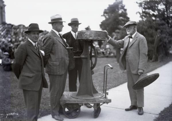 S.M. Babcock, on the right, and his original milk butterfat tester at an honorary ceremony.