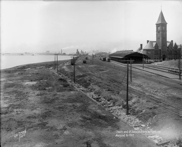 Chicago and North Western Railrod depot at the east end of Wisconsin Avenue. Caption on glass plate reads: "South end of Juneau Park extention [<i>sic</i>]."