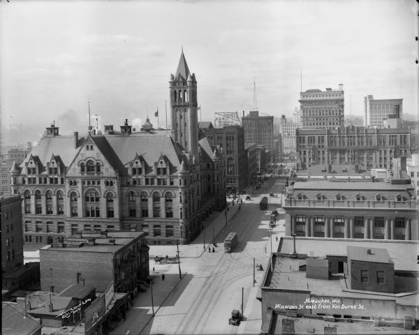 Commercial district looking towards East Wisconsin Avenue from the roof of the Northwestern Mutual Life Insurace home office at Van Buren Street. The Federal Building is on the left. Caption on the glass plate reads: "View of Wisconsin St. east from Van Buren Street."