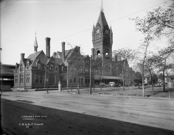 The Chicago, Milwaukee and St. Paul Railroad depot at W. Everett Street between N. 3rd and N. 4th Streets. Caption on glass plate reads: "C. M. & St. P. Depot."