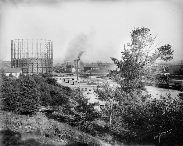Menomonee Valley looking southeast from about N. 27th Street and W. St. Paul Avenue. A Milwaukee Gas Light Co. gas holder is on the left.