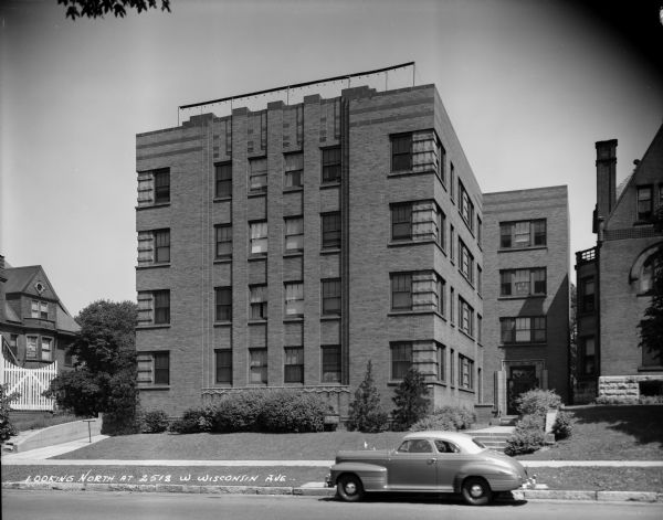 Apartment building at 2518 W. Wisconsin Avenue. Caption on negative reads: "Looking north at 2513 W. Wisconsin Ave". There is a parked automobile in the foreground.