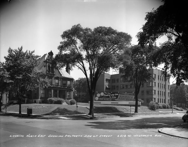W. Wisconsin Avenue and N. 26th Street, looking east. Caption on glass plate reads: "Looking northeast showing property side of street, 2518 W. Wisconsin Ave".