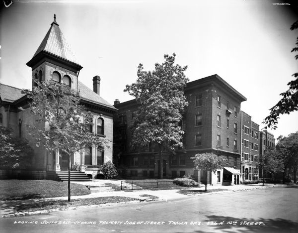 Janola Apartment building located at 836 N. 14th Street. Caption on glass plate reads: "Looking southeast showing property side of street, Janola Apartments, 836 N. 14th Street".