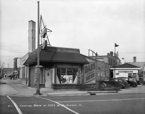 6 point beer garden, 3532 W. Burleigh Street. A gas station, with a sign posted for standard oil products, can be seen to the right. Caption on print reads, "Looking North at 3532 W. Burleigh St."