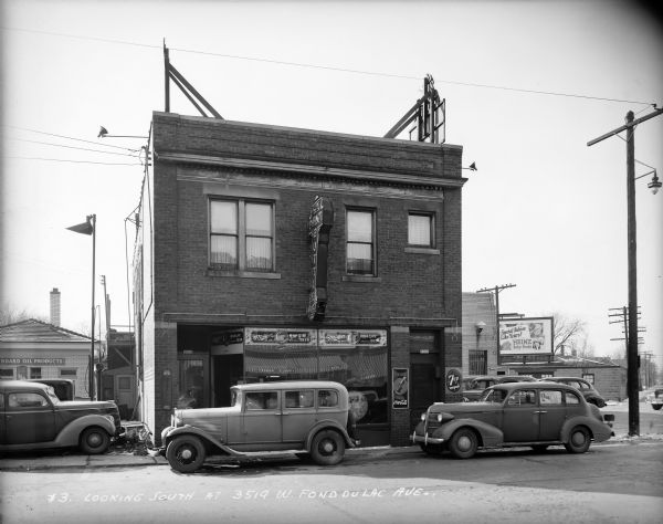 Cars parked in front of Six Point Bottle House (a tavern), 3519 W. Fond du Lac Avenue.