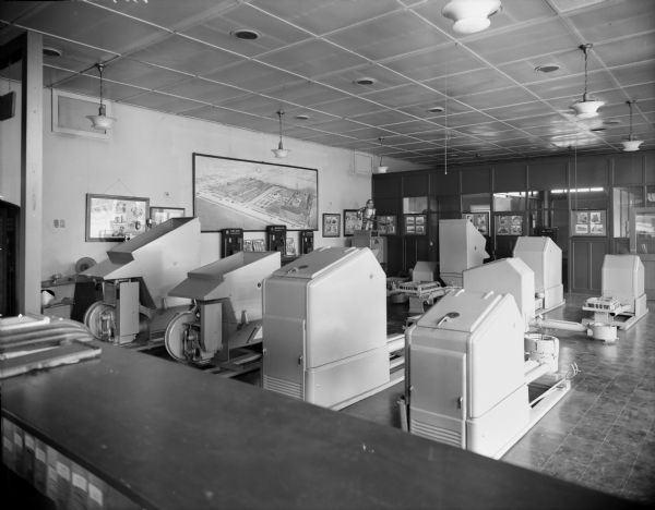 Interior of the Iron Fireman Company furnace showroom with displays of auto coal burners. The business was at 1218 E. Clybourn Avenue in 1930, and then moved to 4507 W. Wisconsin Avenue in 1947.