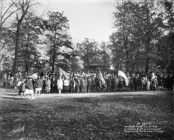 Crowd gathering in Kosciusko Park to celebrate the first anniversary of the formation of the Polish Army in France. Caption on glass plate reads: "Celebration of 1st anniversary of formation of Polish army in France".