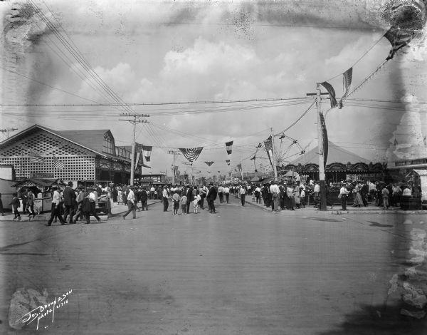 Crowds of individuals at the fair, presumable the Wisconsin State Fair.