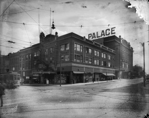 View from across the street of the Palace Theater, 535 West Wisconsin Avenue. A streetcar is approaching from the left.