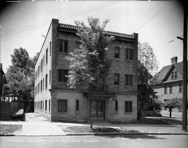 Apartment building with caption reading, "Looking south at 719 East Pleasant Street."