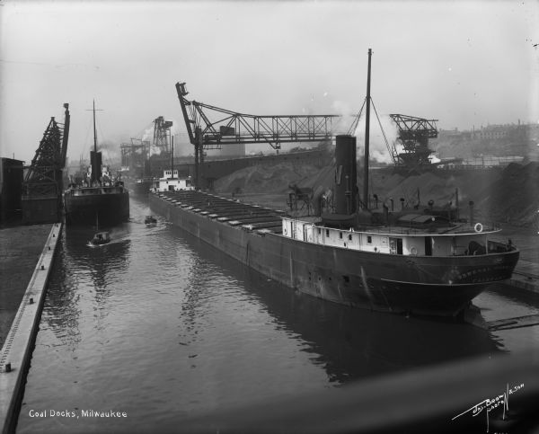 A large, coal cargo ship docks in the harbor in Menominee Valley.