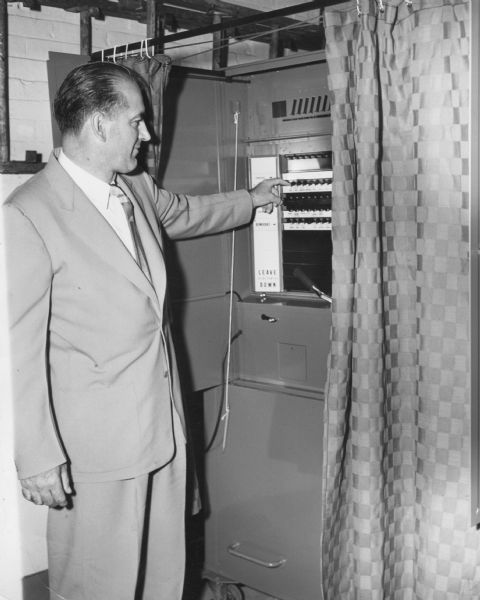 For the camera, Senator Joseph R. McCarthy shows how he voted in the 1952 Republican Primary. McCarthy handily defeated his opponent Len Schmitt.