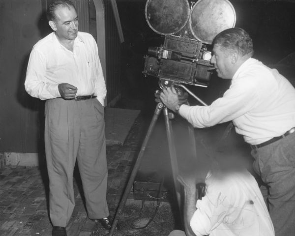 Senator Joseph R. McCarthy being interviewed by a newsreel crew after his victory in the 1952 Republican primary election. McCarthy was celebrating at the Appleton home of his friend and campaign manager Urban Van Susteren. On the original print, the head of the second member of the crew has been blacked out and the image cropped for publication.