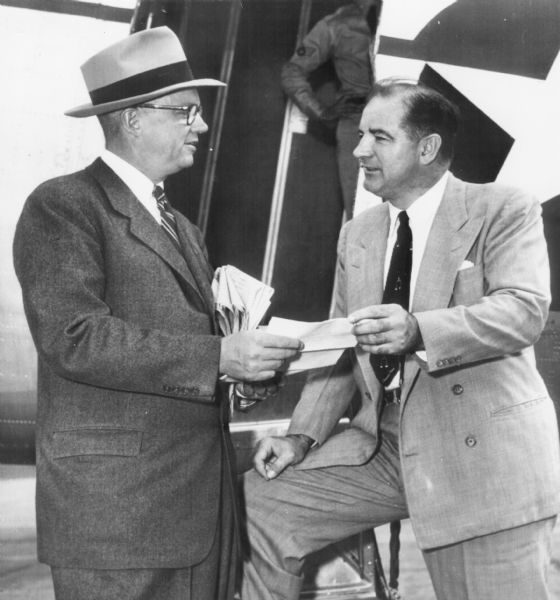 As chairman of the Senate Investigating Committee Senator Joseph R. McCarthy traveled to New York City to hold closed hearings on alleged Communist espionage within the Army Signal Corp Laboratory located at Fort Monmouth, New Jersey.  With him as he is about to take off from the Washington airport is Secretary of the Army Robert Stevens.  Stevens attended the closed hearing as McCarthy's guest.  The open hearings in Washington began on November 24, 1953.