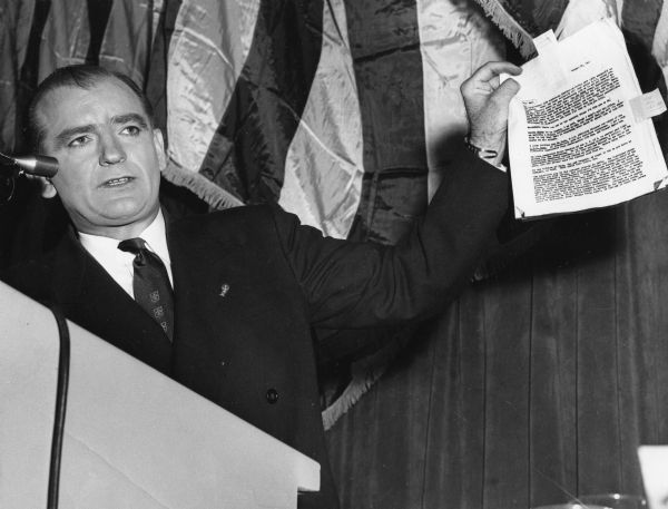 Senator Joseph R. McCarthy of Wisconsin holding up a report on Democratic Presidential candidate Adlai E. Stevenson that linked him to a host of extreme left-wingers, even Alger Hiss. This address was broadcast on national television.