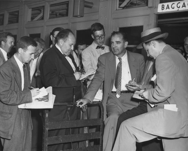 Senator Joseph R. McCarthy speaking with reporters at LaGuardia Airport shortly after his victory over Len Schmitt in the Wisconsin Republican primary. McCarthy had felt so confident of his victory margin that he had been touring other states to campaign in behalf of other anti-Communist Republicans. McCarthy told reporters at the airport that he would campaign for Dwight Eisenhower if asked by the candidate. Eisenhower had already formed a personal dislike for McCarthy, and rather than asking for McCarthy's aid, Eisenhower did everything he could to avoid being seen with the senator.