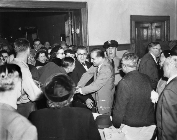 Joseph R. McCarthy receiving the congratulations of supporters after his victory over Democrat Howard J. McMurray in the 1946 U.S. Senate election. The victory party was held at the Hotel Appleton.