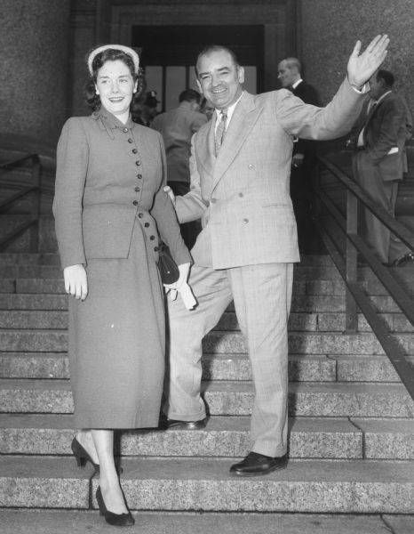 Senator Joseph R. McCarthy and his new bride, the former Jean Kerr, arrive at the federal building in New York City where a hearing concerning security risks at Fort Monmouth was taking place.  McCarthy canceled a three-week honeymoon in the Bahamas in order to take part in the hearing.  McCarthy, long considered one of the most eligible bachelors in Washington, D.C., married his legislative assistant on September 23.  Over 1000 guests attended their wedding.