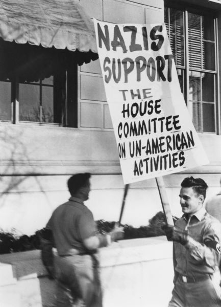 Members of the Nazi Party demonstrating in behalf of the House Un-American Activities Committee (HUAC). This photograph is part of the records of the National Committee Against Repressive Legislation which was formed in 1960 as the National Committee to Abolish the House Un-American Activities Committee. Although the censure of Senator Joseph R. McCarthy is often cited as end of extreme anti-Communism, HUAC continued until the mid 1970s.