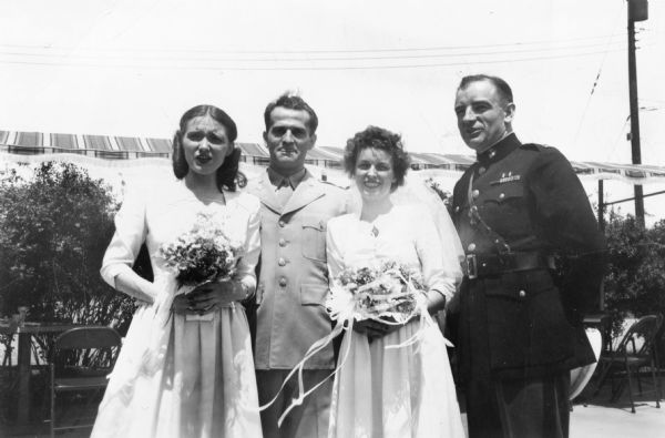 Joseph R. McCarthy in his Marine uniform acting as best man at the wedding of his best friend (and later campaign manager), Urban Van Susteren, at Syracuse Army Air Force Base. Helen Burke, the maid of honor, is on the left.