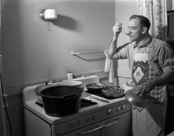 Recently-elected Senator Joseph R. McCarthy tasting a favorite recipe for pheasant during vacation.