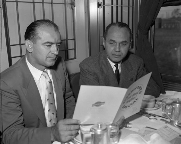 Senator Joseph R. McCarthy and Governor Walter J. Kohler, Jr., seated together in the Eisenhower Presidential campaign train dining car.