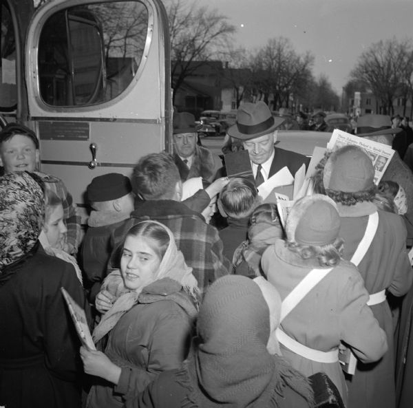 Presidential candidate Harold E. Stassen, standing by his campaign bus, beseiged by young autograph collectors. On January 29, Stassen, a former governor of Minnesota, was the first Republican to file in the Wisconsin Presidential Primary. Questioned about his support for Senator Joseph R. McCarthy in the Senate race, Stassen declined to comment. In 1948 McCarthy had been a Stassen delegate, but he was not on Stassen's 1952 slate.