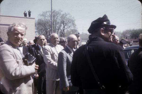 Official representatives at the funeral of Senator Joseph R. McCarthy included (third from the police officer) Governor Walter J. Kohler, Jr.