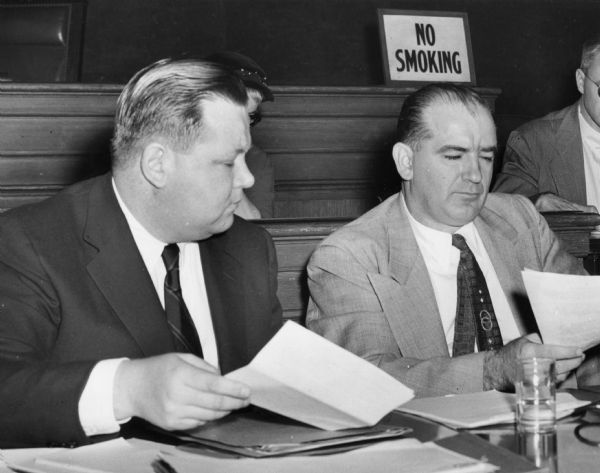 Senator Joseph R. McCarthy and Francis P. Carr at the first public session of the investigation of espionage at Fort Monmouth, New Jersey.  Carr read into the record a transcript of an interview between convicted spy David Greenglass and members of McCarthy's staff.  Greenglass was the brother of Ethel Rosenberg, along with her husband Julius, had been executed for stealing atomic secrets for the Russians.