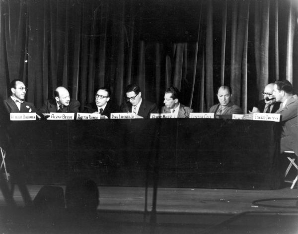Eight members of the Hollywood Ten at an unidentified event concerning their defense. From left to right are Herbert Biberman, Alvah Bessie, Dalton Trumbo, Ring Lardner, Jr., Albert Maltz, Lester Cole, Samuel Ornitz, and Edward Dmytryk.