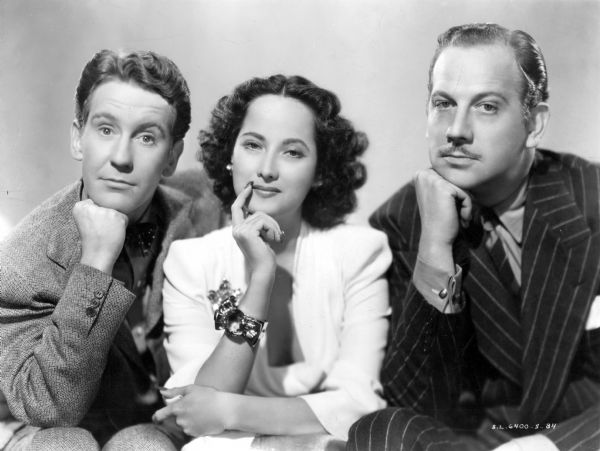 Burgess Meredith, Merle Oberon, and Melvyn Douglas in a publicity still for <i>That Uncertain Feeling</i> (United Artists, 1941).