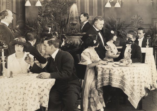 The characters Lorna Barton (played by Ethel Grandin) and Bill Bradshaw (William Cavanaugh) in a cafe scene from <i>Traffic in Souls</i> (1913, IMP).