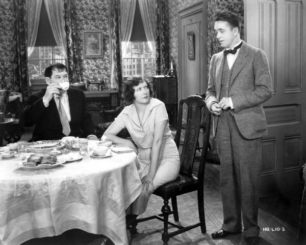 Oliver Hardy, Mae Busch, and Stan Laurel in <i>Their First Mistake</i> (MGM 1932).