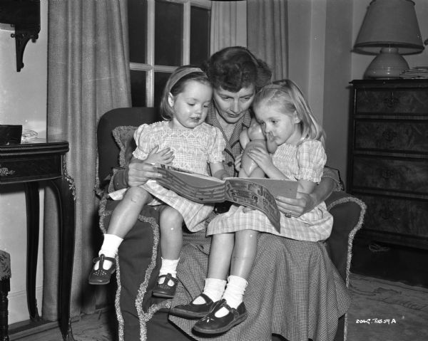 Celia Johnson reading to two small girls, probably her daughters Kate and Lucy.