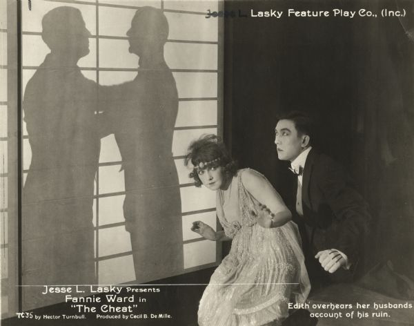 Dramatic publicity still of Fannie Ward (playing Edith Hardy) and Sessue Hayakawa (as Hishuru Tori) in "The Cheat" (Lasky, 1915). Original caption: "Edith overhears her husband's account of his ruin."