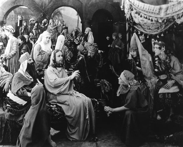 A crowded scene still from "Intolerance": Christ at the wedding at Cana with Howard Gaye as Christ, and with Bessie Love and George Walsh as the bride and groom.