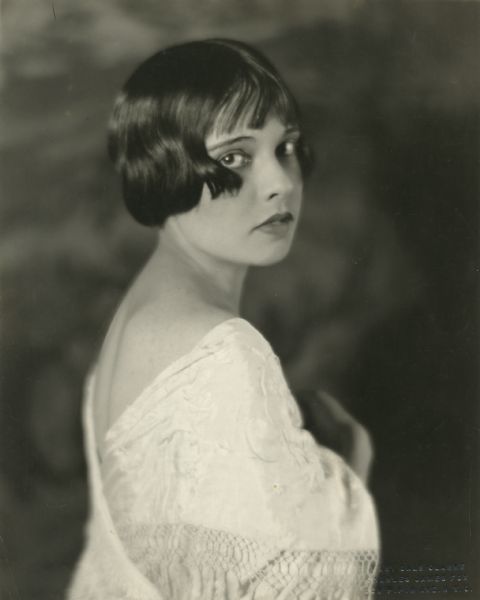 Over-the-shoulder portrait of the writer Anita Loos made by Charles James Fox in New York. With her bobbed hair and sharp sense of humor, Loos was the epitome of the 1920's flapper.
