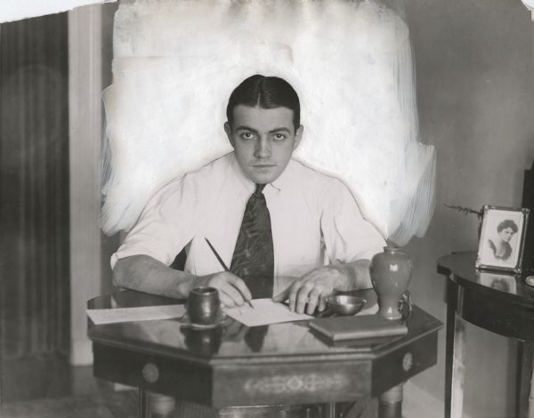 A water-damaged, thoroughly-retouched publicity still of Richard Barthelmess sitting at a writing desk. It apparently appeared in "Photoplay Magazine" sometime after December 13, 1917.

Original caption:
"He is not exclusively an actor, but is continuing his study of languages, natural sciences and literary composition."