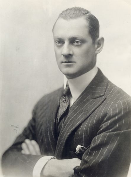The actor Lionel Barrymore in a studio portrait by Herman Miskin of New York. His arms are crossed, and he wears a pinstriped suit.

A caption pasted on the back of the print:
"LIONEL BARRYMORE, prominent member of the famous Barrymore-Drew family, has renounced the spoken and silent drama and will soon direct his sister, ETHEL BARRYMORE, in Metro de luxe productions and wonderplays."