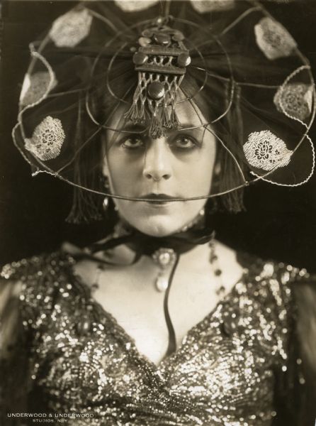 Publicity still of Valeska Suratt wearing a hat composed mostly of wires, c. 1916.

A stamp on the back of the print reads:
William Fox presents VALESKA SURATT in photo plays supreme released through FOX FILM CORPORATION.