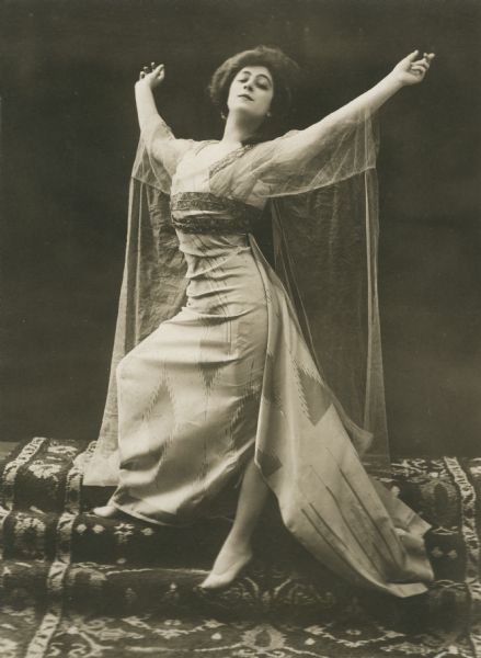 Valeska Suratt starred in the 1910 play <i>The Girl with the Whooping Cough.</i> The stamp on the back of the print reads:
"A.H. Woods presents VALESKA SURATT in the greatest Parisian sensation <i>The Girl with the Whooping Cough."</i>