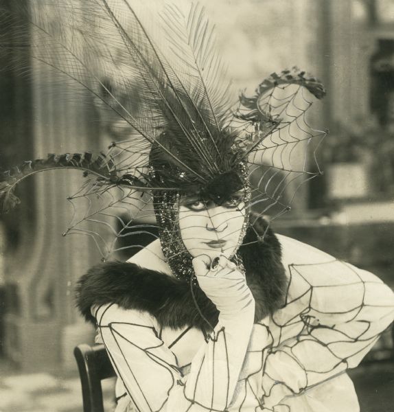 Valeska Suratt wears a spider dress and on her head is a webbed hat, proof positive that she is a vamp.
