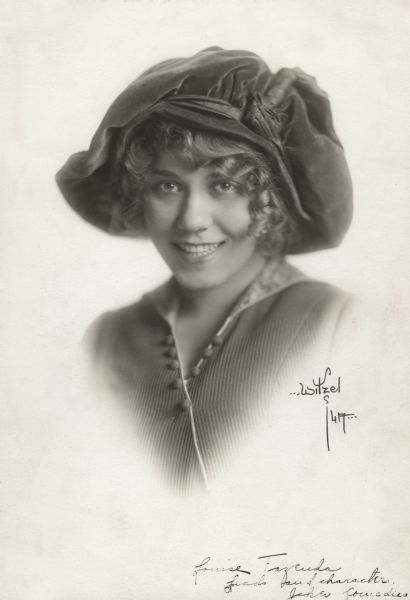 Portrait photograph of Louise Fazenda wearing a large floppy hat when she acted for the Joker Comedy unit at Universal.

The handwritten caption at the bottom of the print reads:
"Louise Fazenda, leads and characters, Joker Comedies."