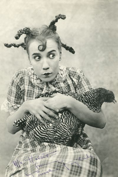 Publicity still of Louise Fazenda in her country girl costume holding a chicken, possibly for the 1920 Mack Sennett film <i>Down on the Farm.</i>